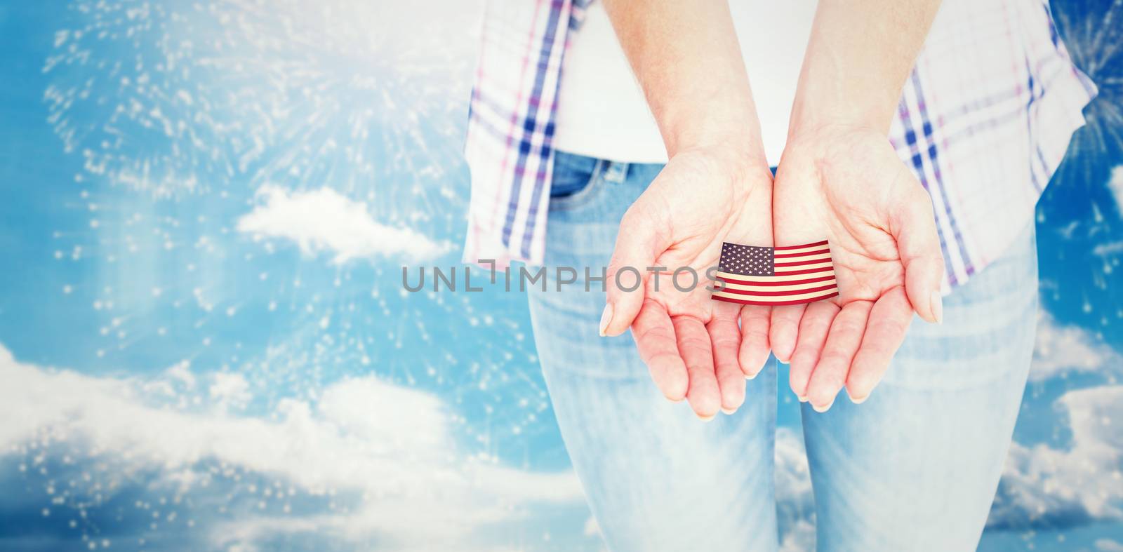 Hipster showing her hands  against colourful fireworks exploding on black background