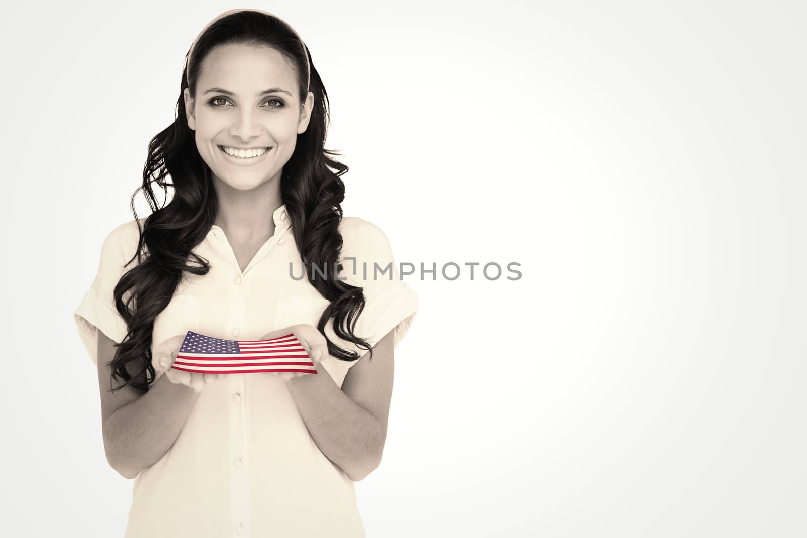 Pretty brunette holding out hands against usa national flag