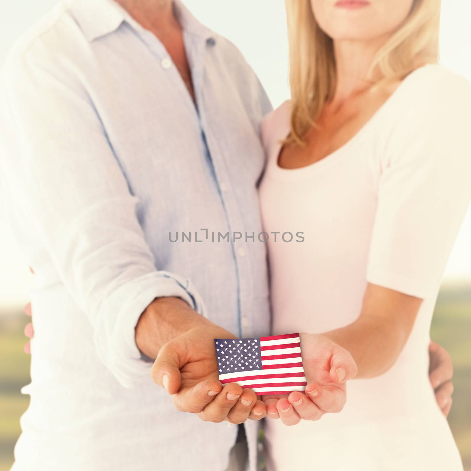 Happy couple holding their hands out against scenic landscape