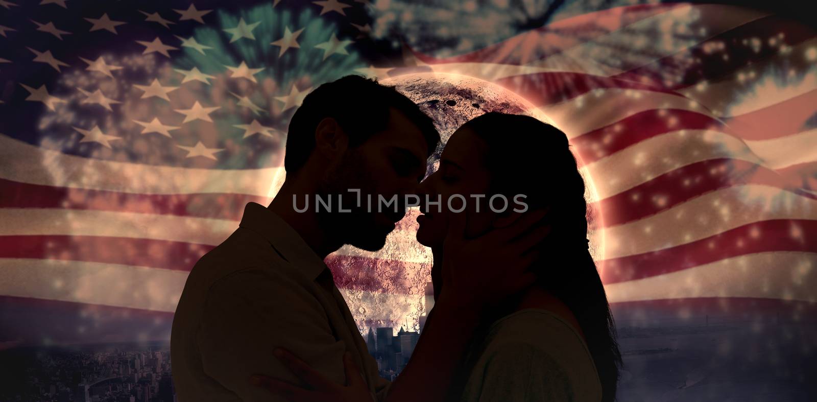 Attractive young couple about to kiss against colourful fireworks exploding on black background