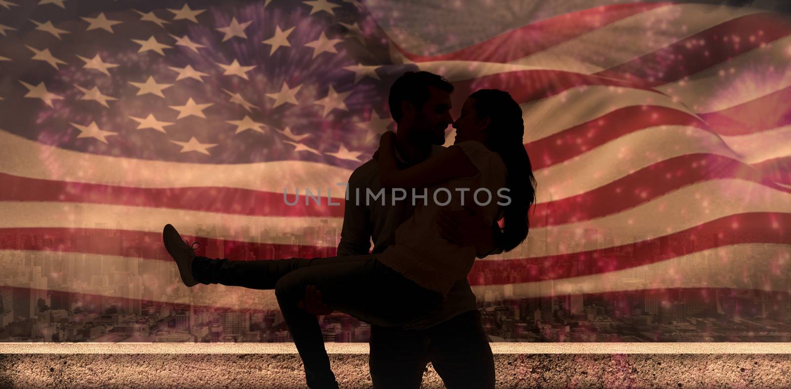 Attractive young couple having fun against colourful fireworks exploding on black background