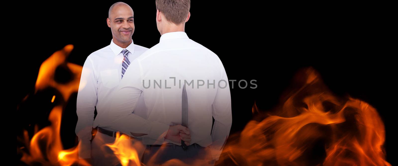 Composite image of businessman holding knife behind his back by Wavebreakmedia