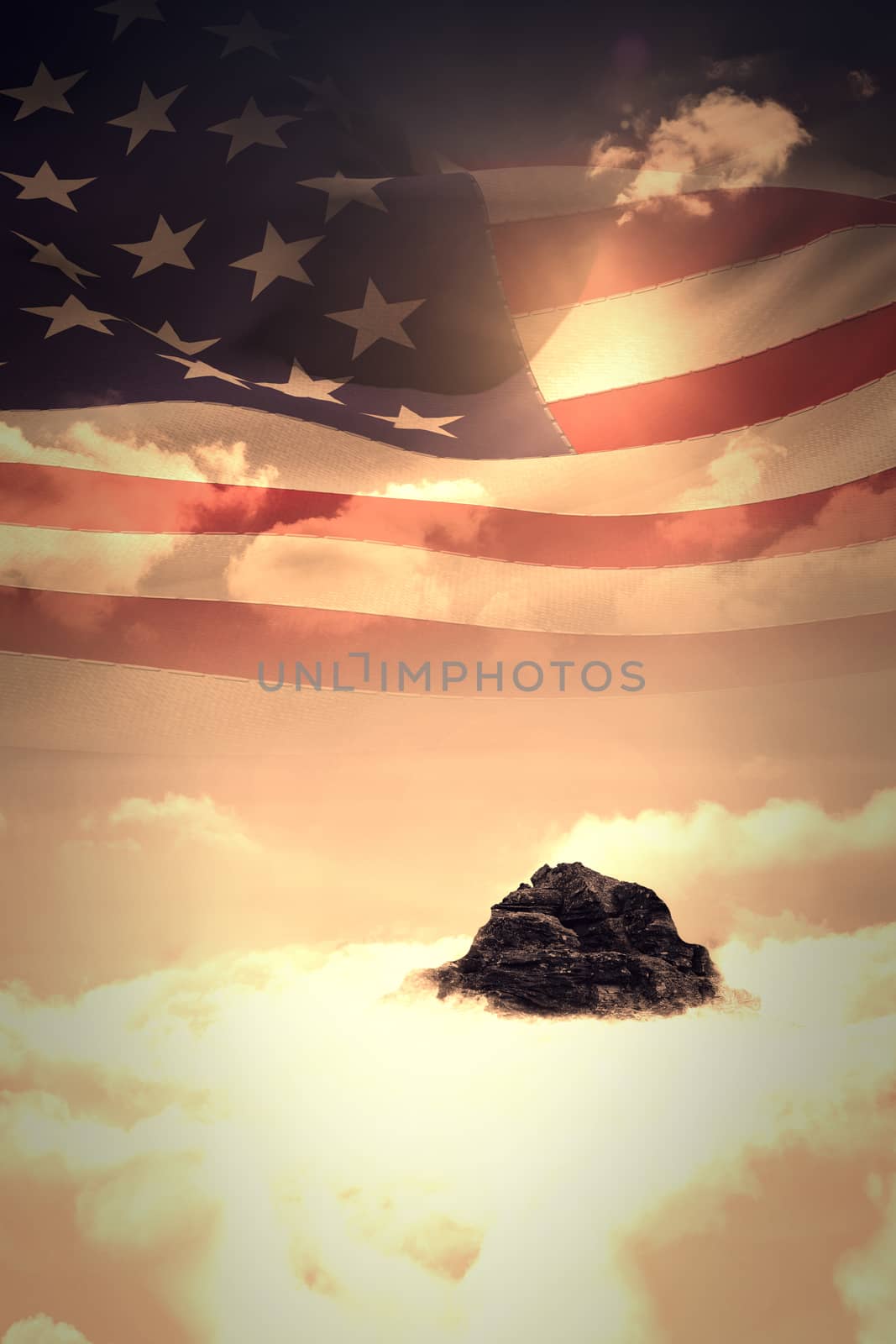 Digitally generated american flag rippling against mountain peak through the clouds