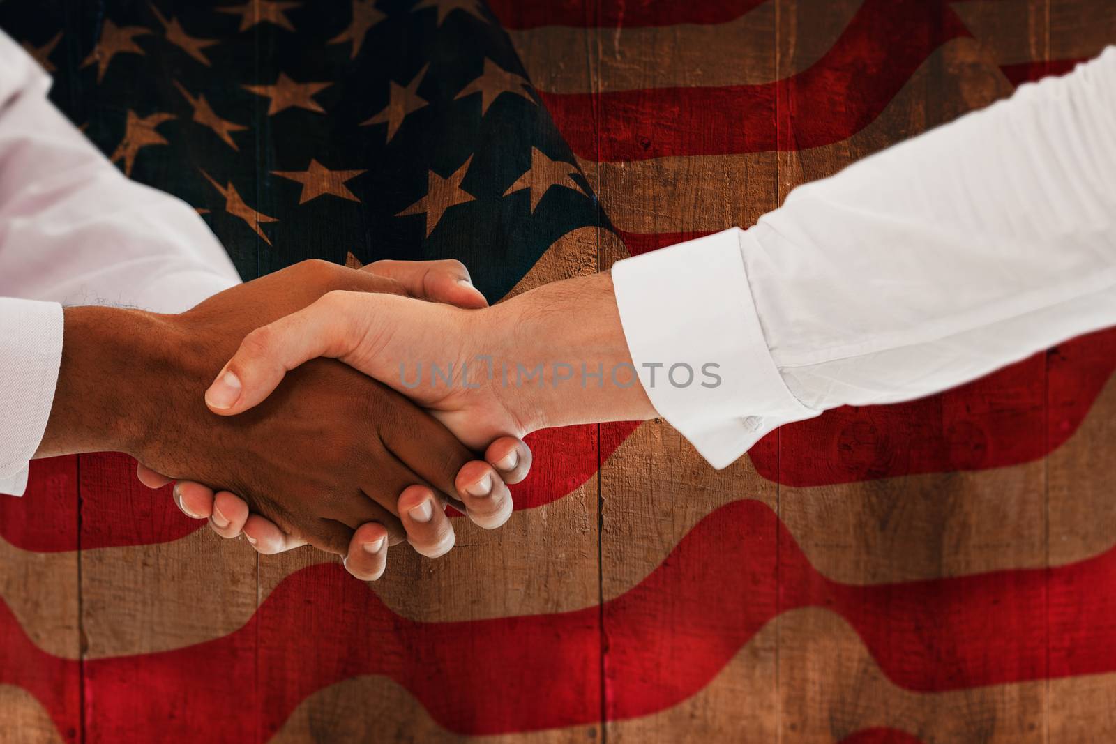 Composite image of close-up shot of a handshake in office by Wavebreakmedia