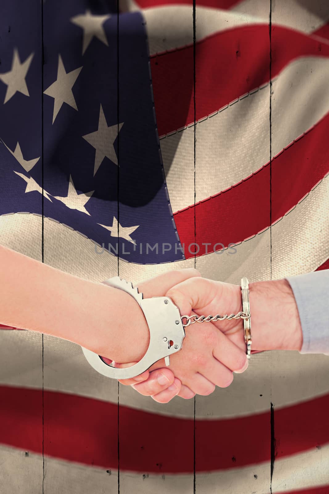 Composite image of handcuffed business people shaking hands by Wavebreakmedia