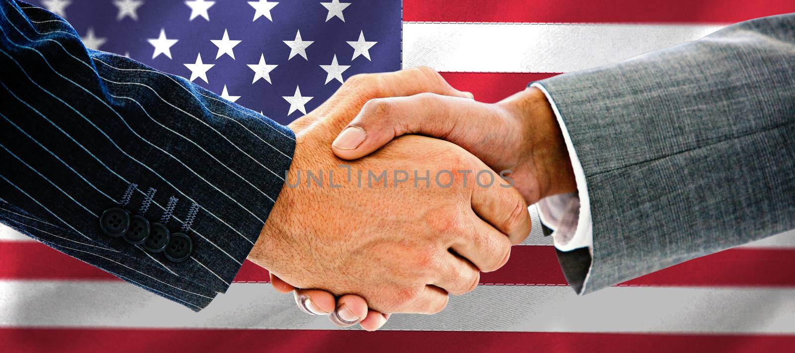 Business people shaking hands against black wall