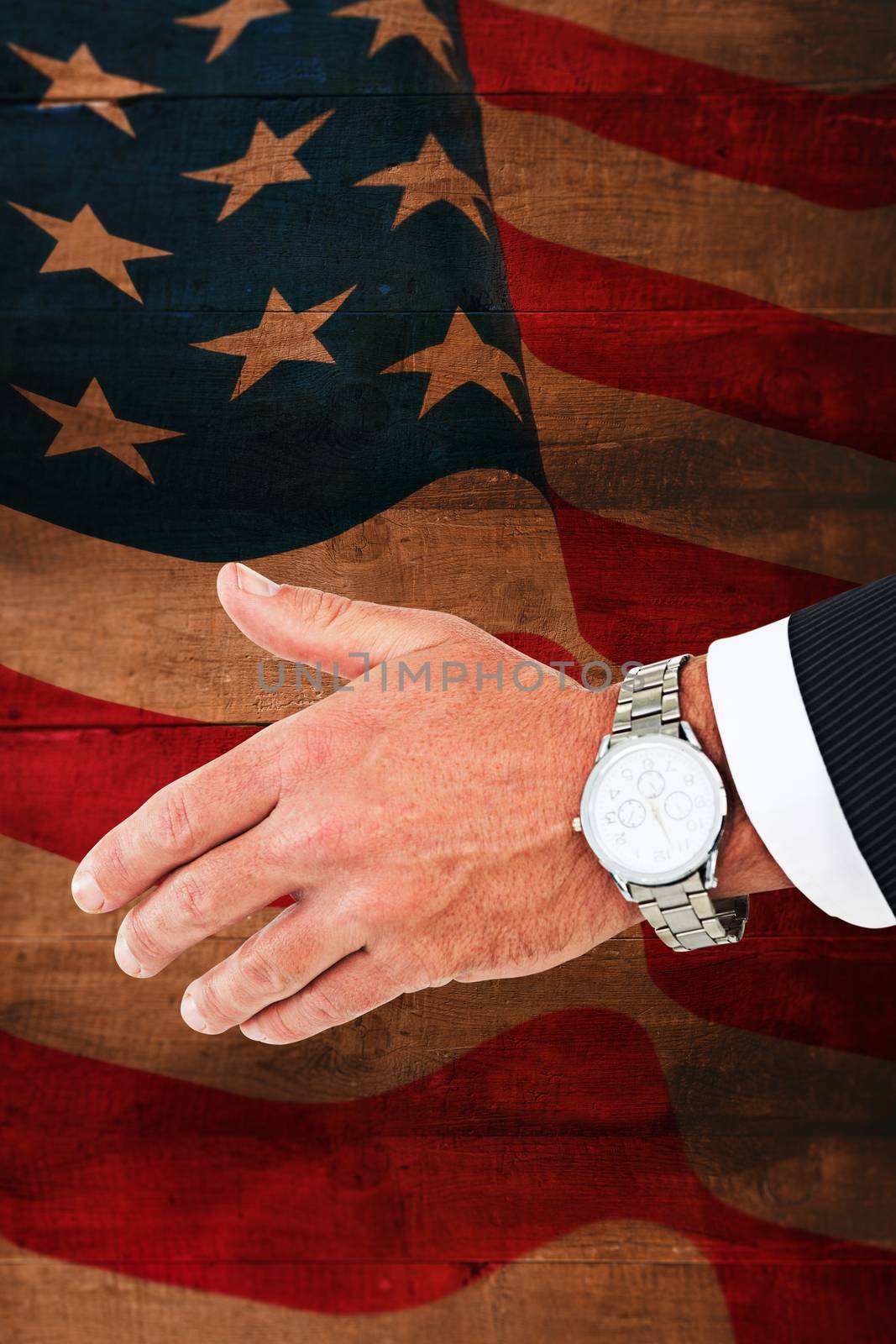 Businessman in suit clenching fists against weathered oak floor boards background