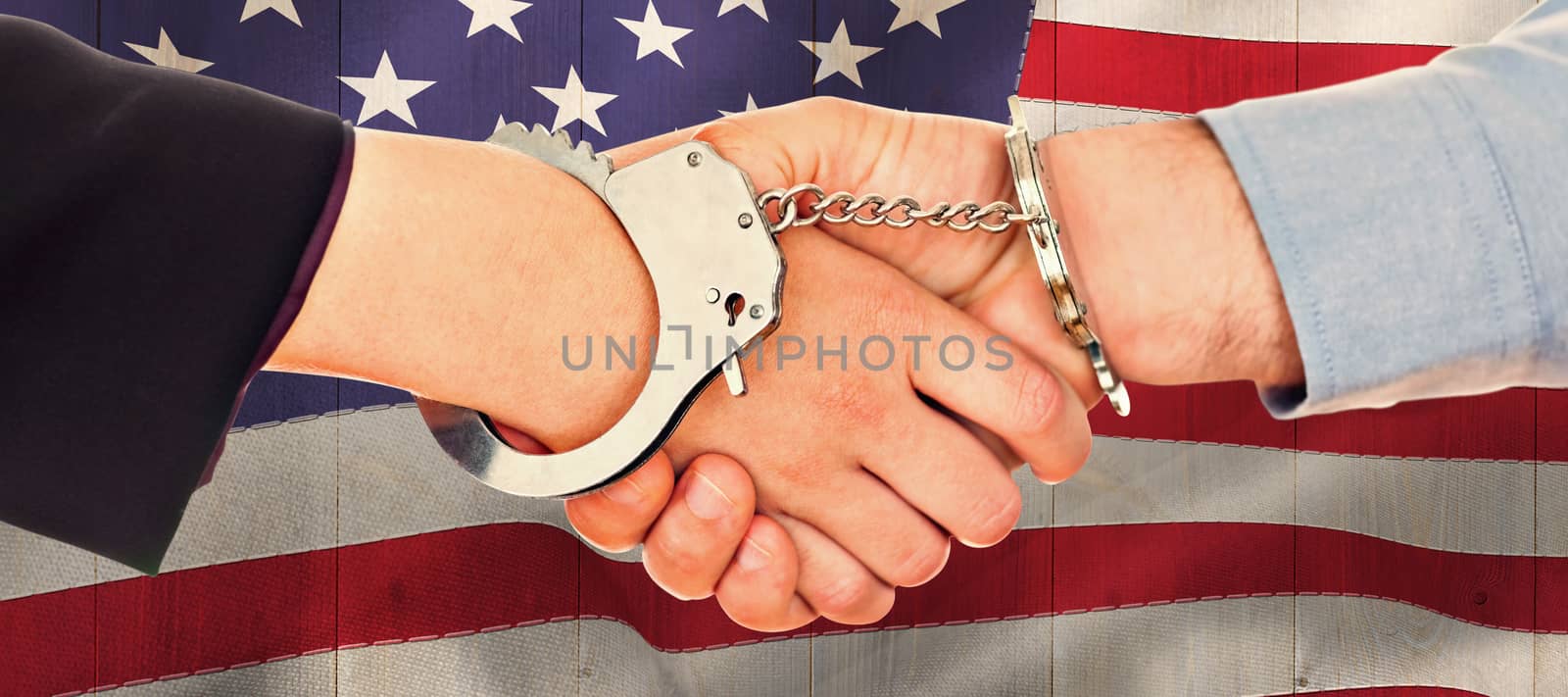 Composite image of business people in handcuffs shaking hands by Wavebreakmedia