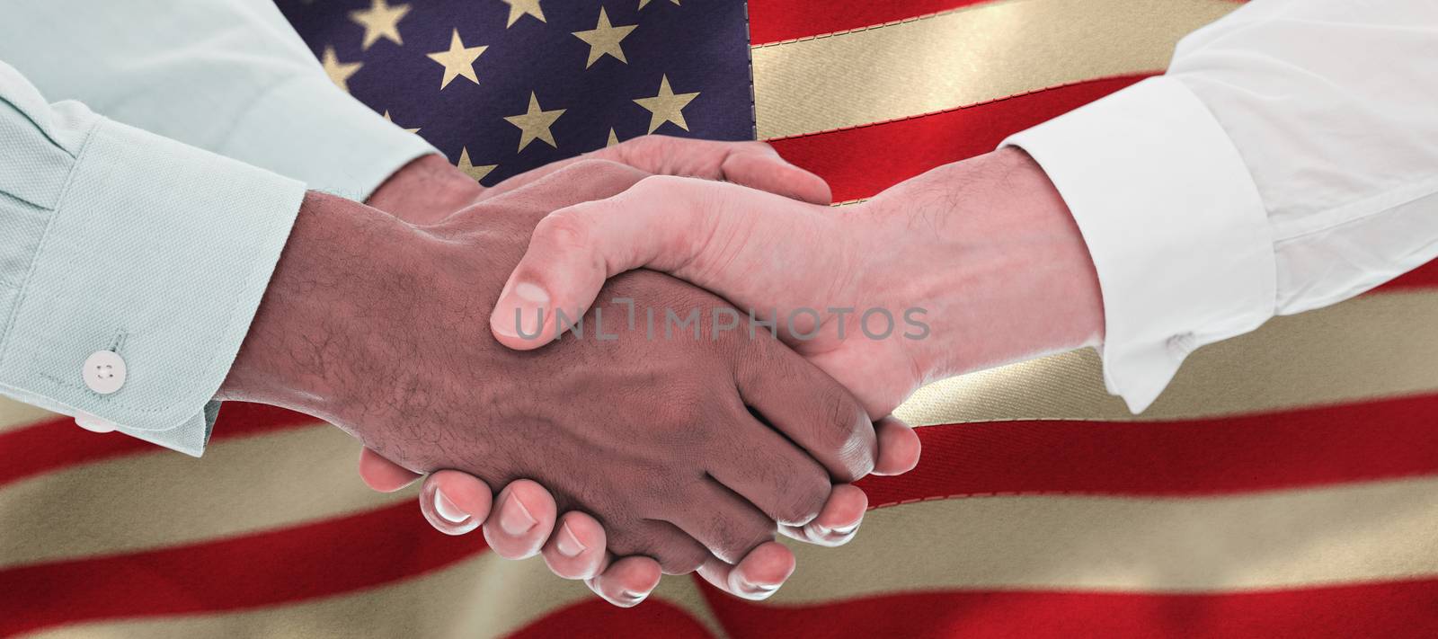 Close-up shot of a handshake in office against beige