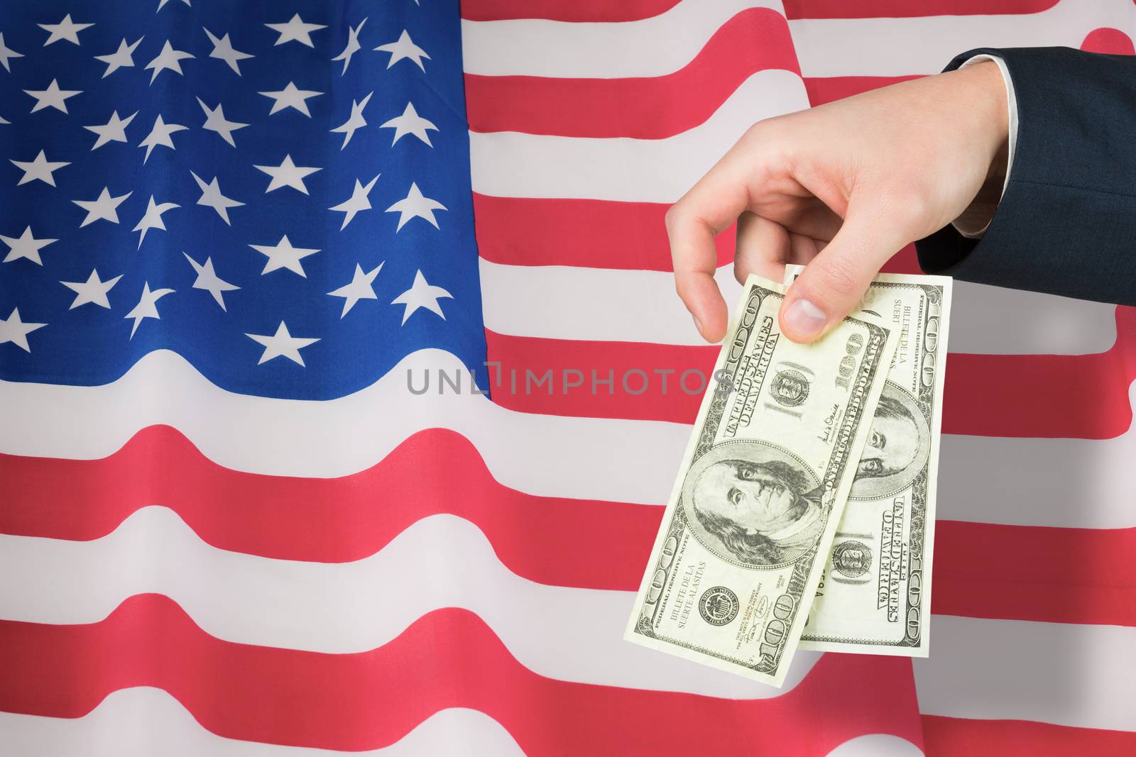 Composite image of hand holding hundred dollar bills by Wavebreakmedia