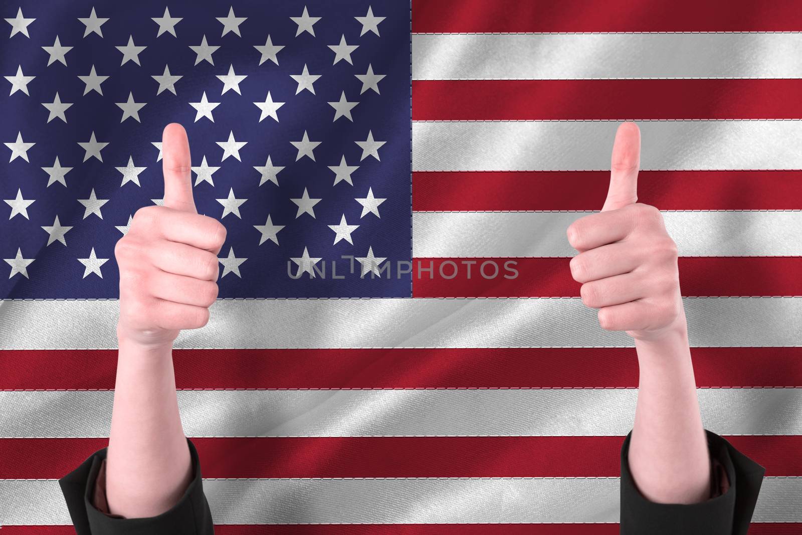 Businesswomans hands showing thumbs up against digitally generated american national flag