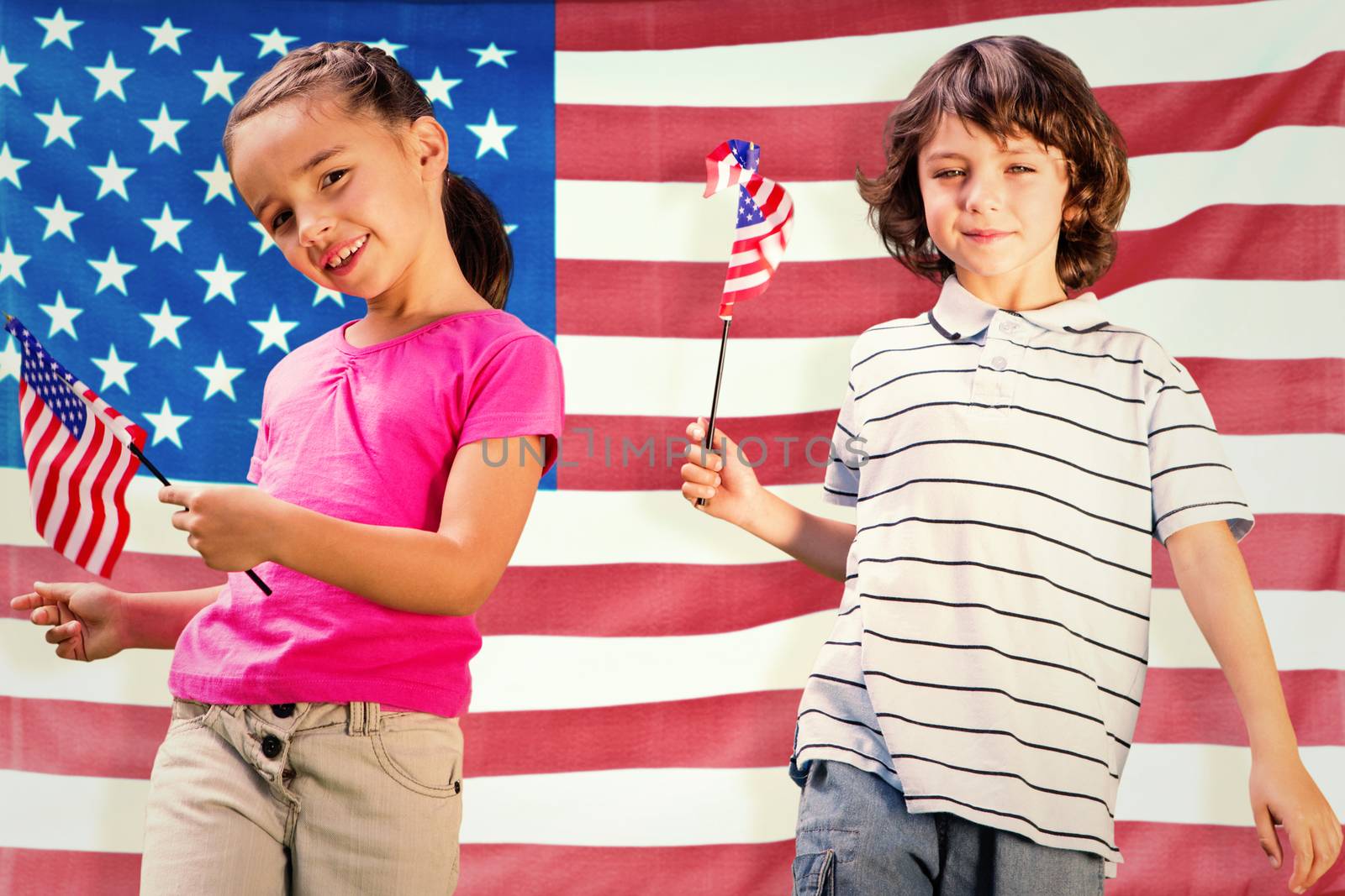 Children with american flags against rippled us flag