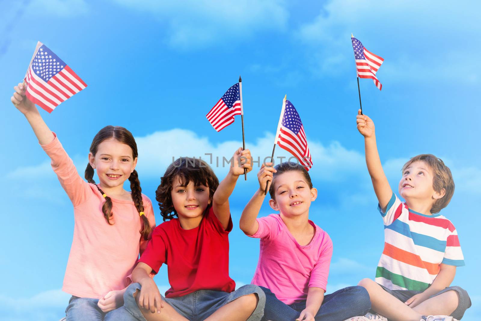 Composite image of children with american flags by Wavebreakmedia