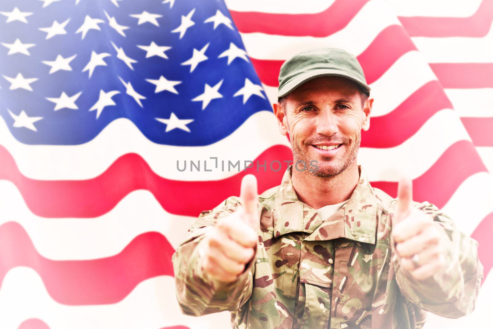 Soldier showing thumbs up against rippled us flag