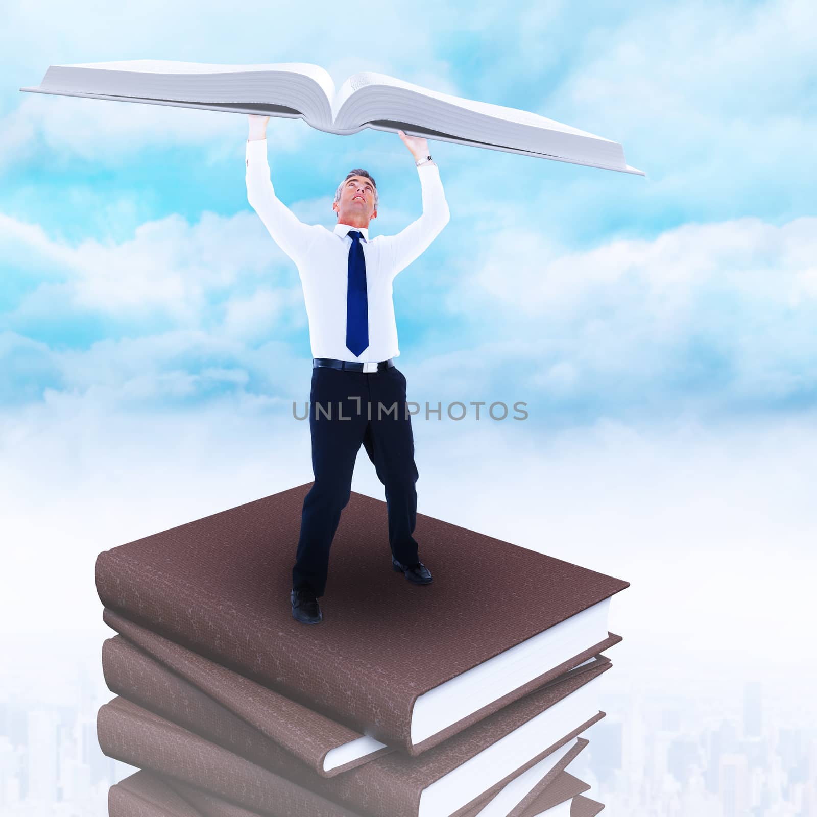 Businessman with arms up against clouds over city