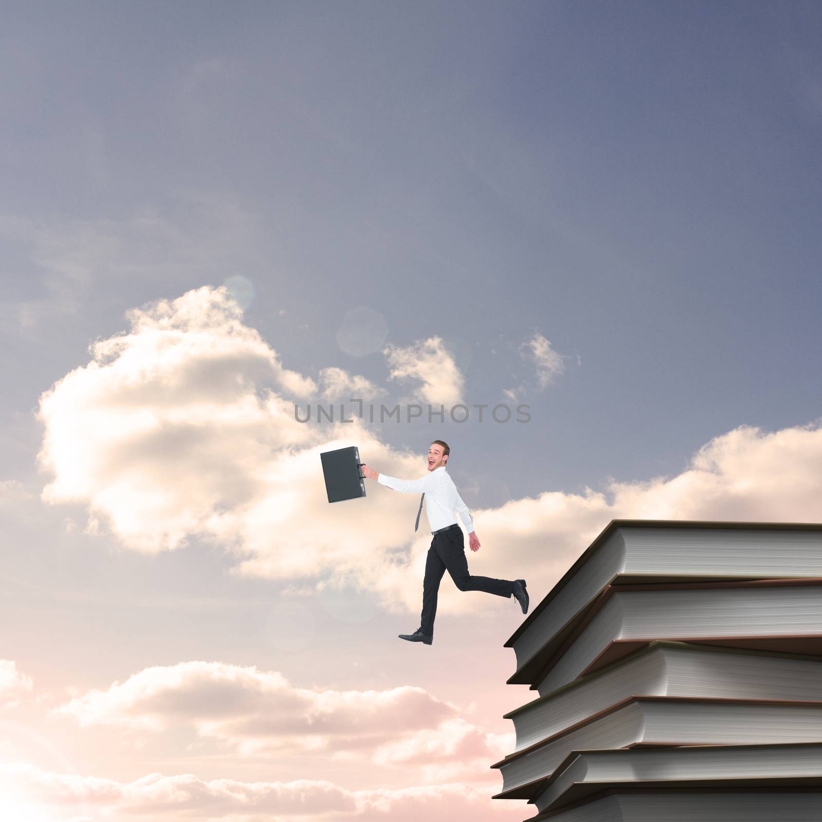 Happy businessman leaping with his briefcase against blue sky with white clouds