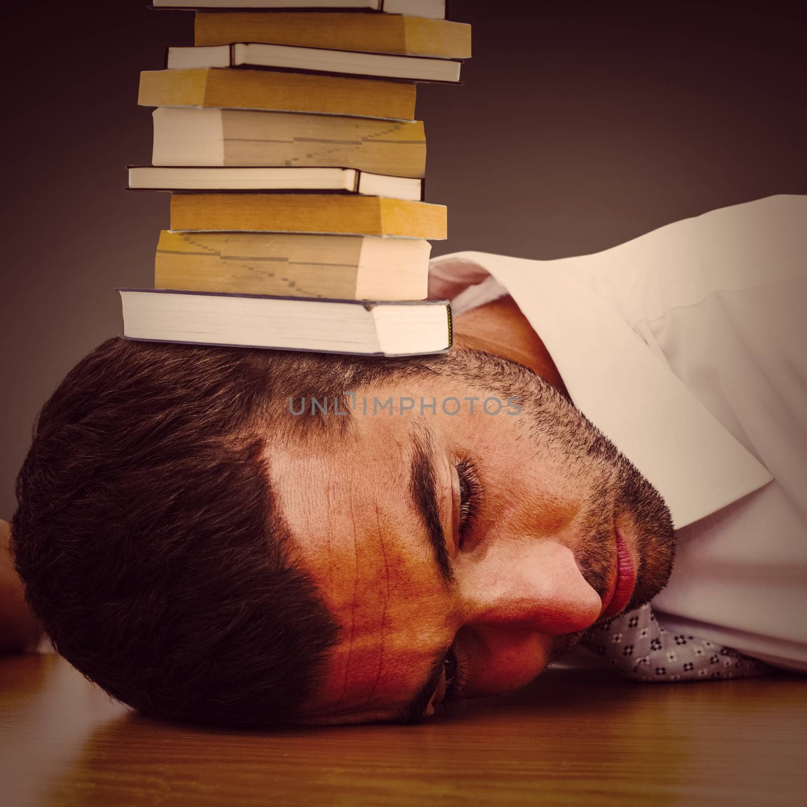 Composite image of tired businessman resting on his desk  by Wavebreakmedia