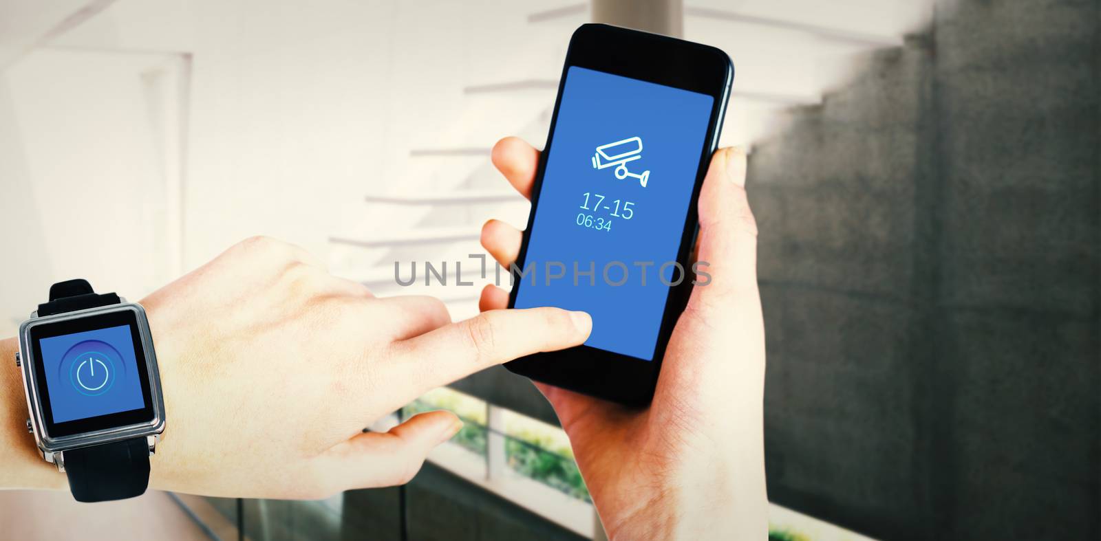 Woman using smartwatch and phone against stylish modern home interior with staircase