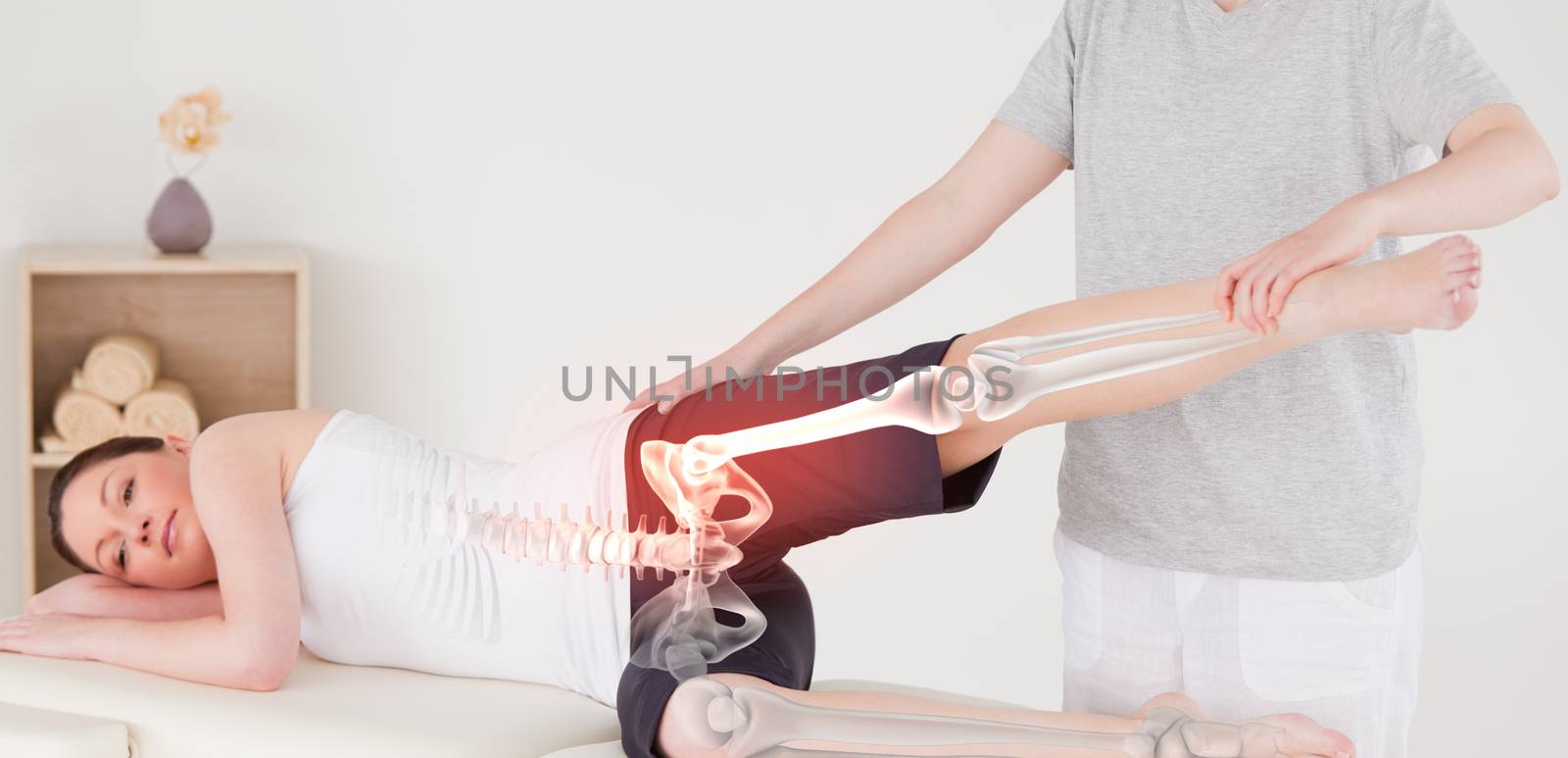 Digital composite of Highlighted bones of woman at physiotherapist 