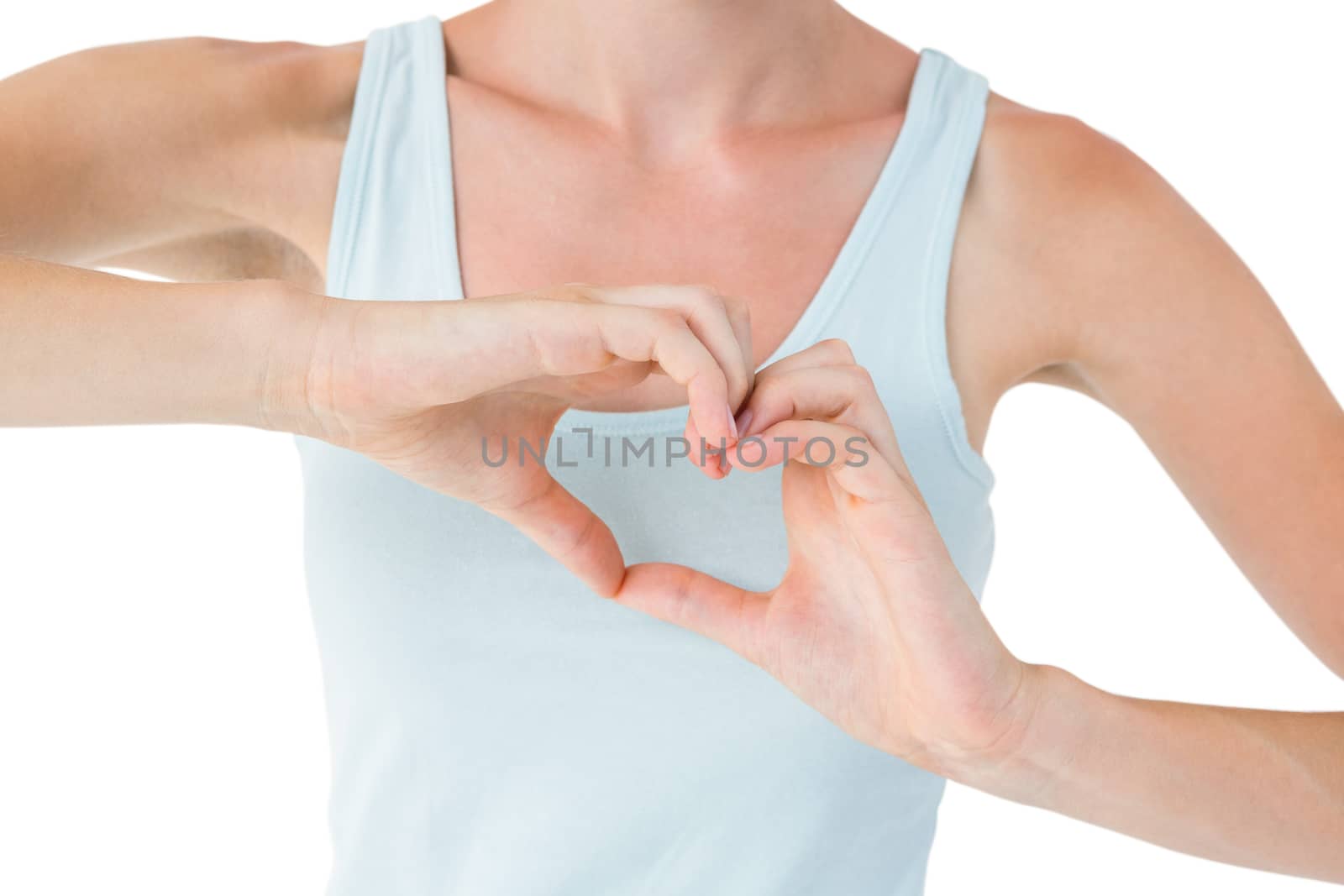 Fit woman doing heart shape with her hands on white background