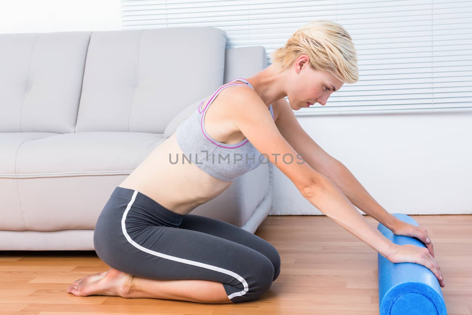 Fit blonde woman working out with foam roller