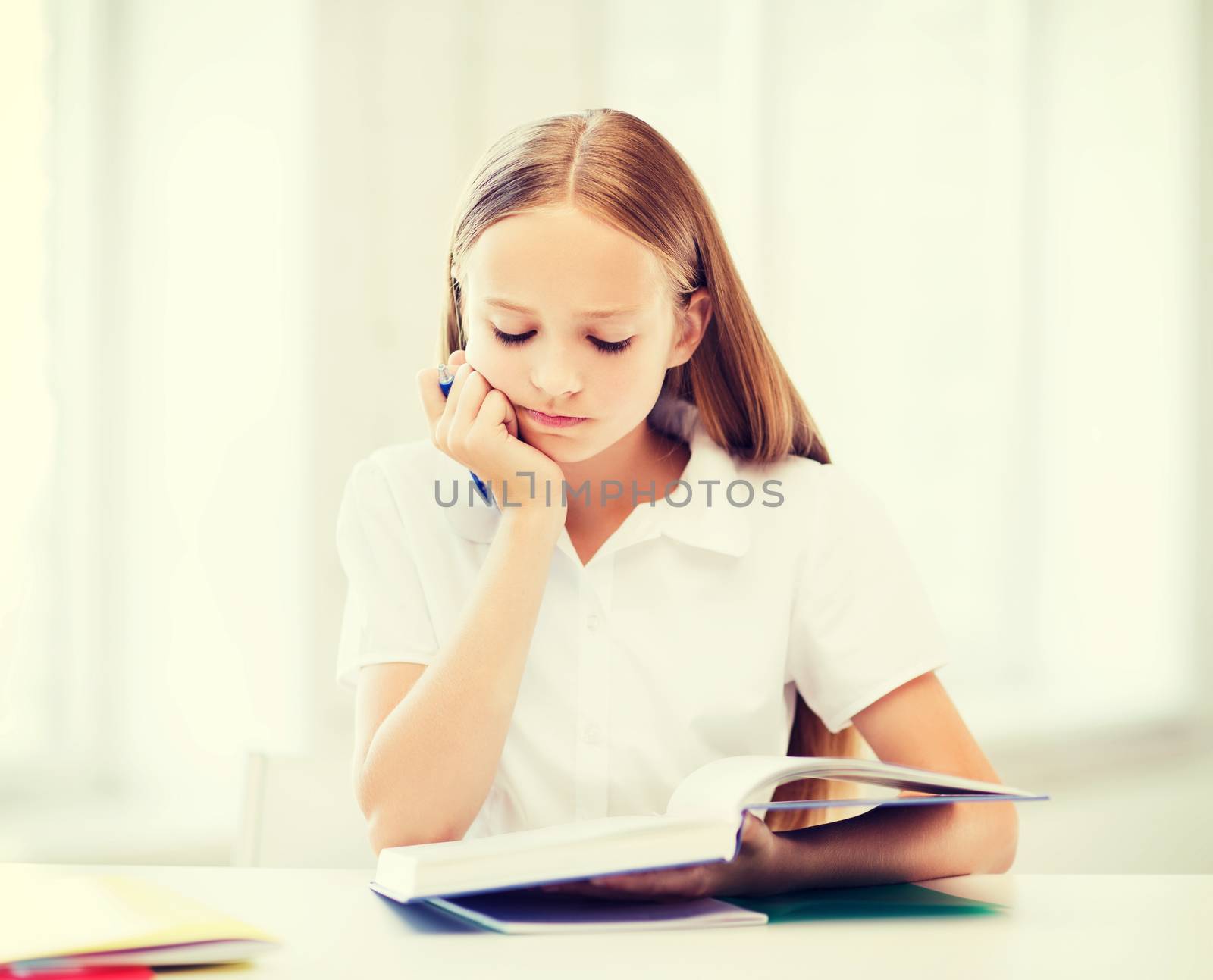 student girl studying at school by dolgachov
