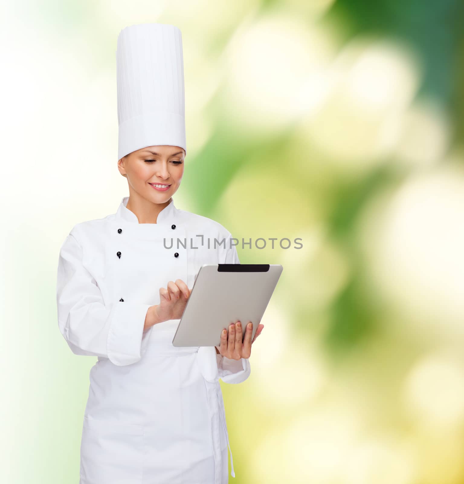 smiling female chef with tablet pc computer by dolgachov