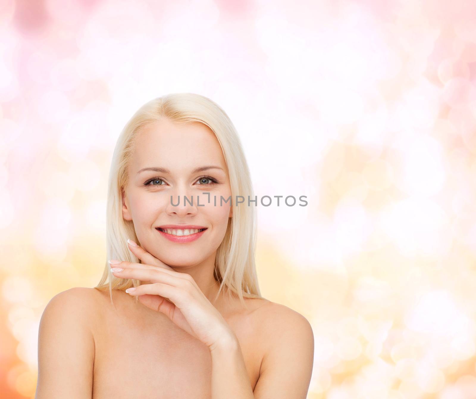 health and beauty concept - face and hands of beautiful woman
