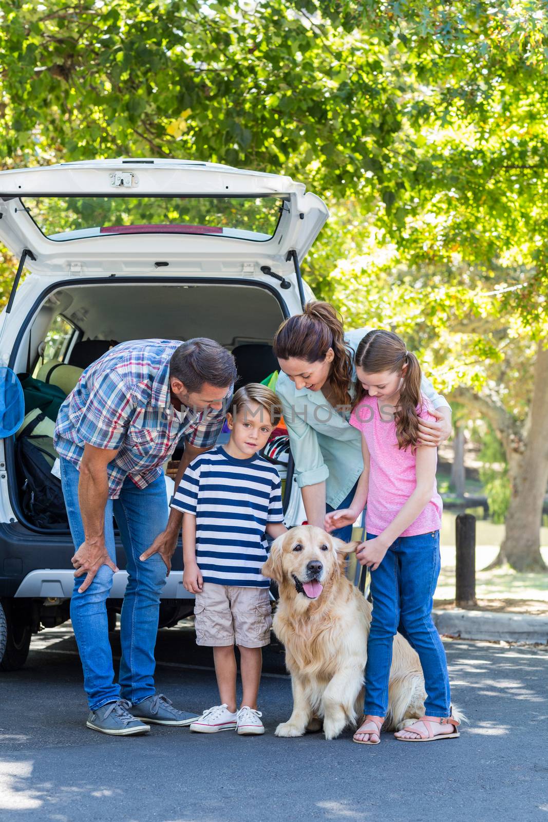 Happy family getting ready for road trip on a sunny day