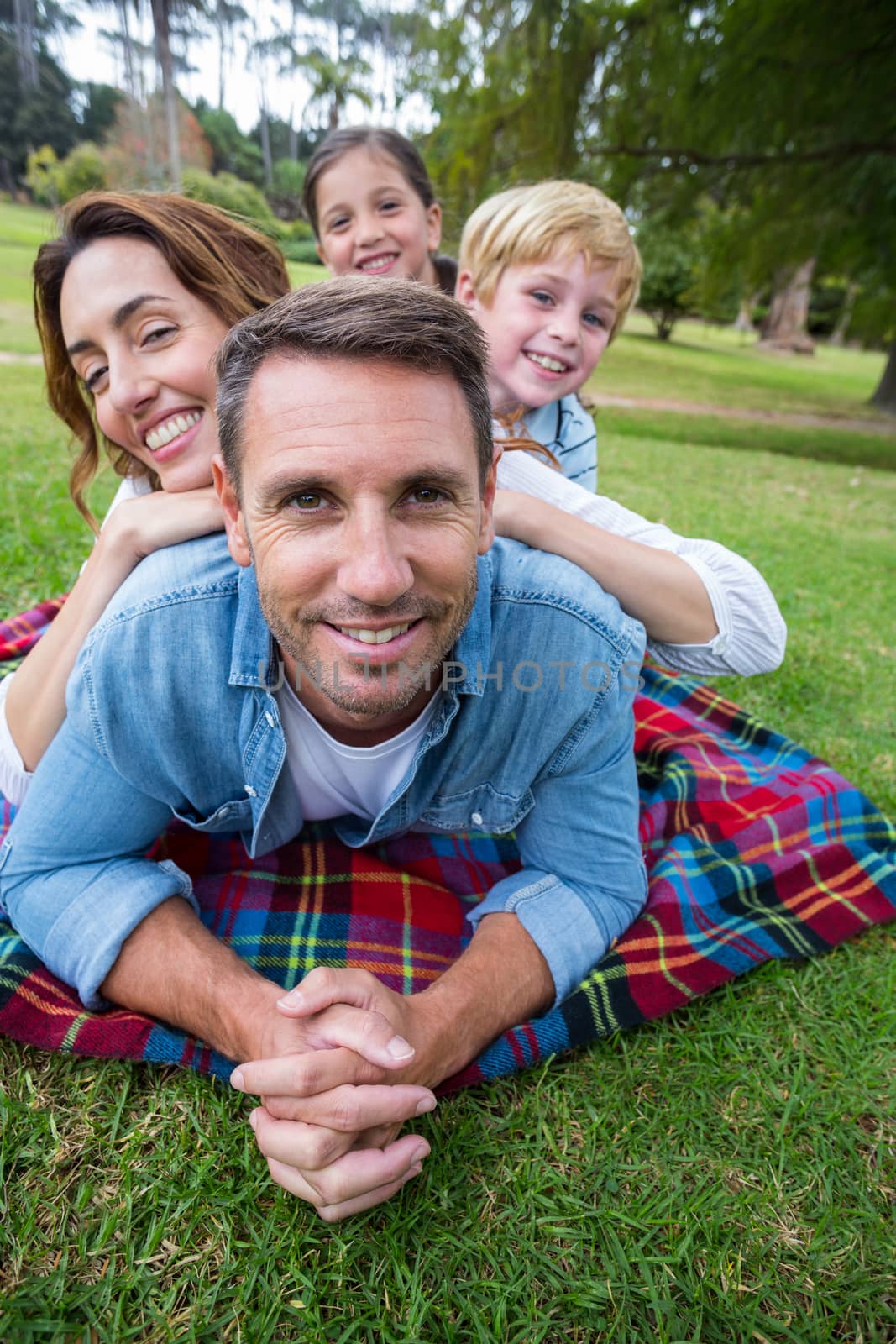 Happy family in the park together by Wavebreakmedia