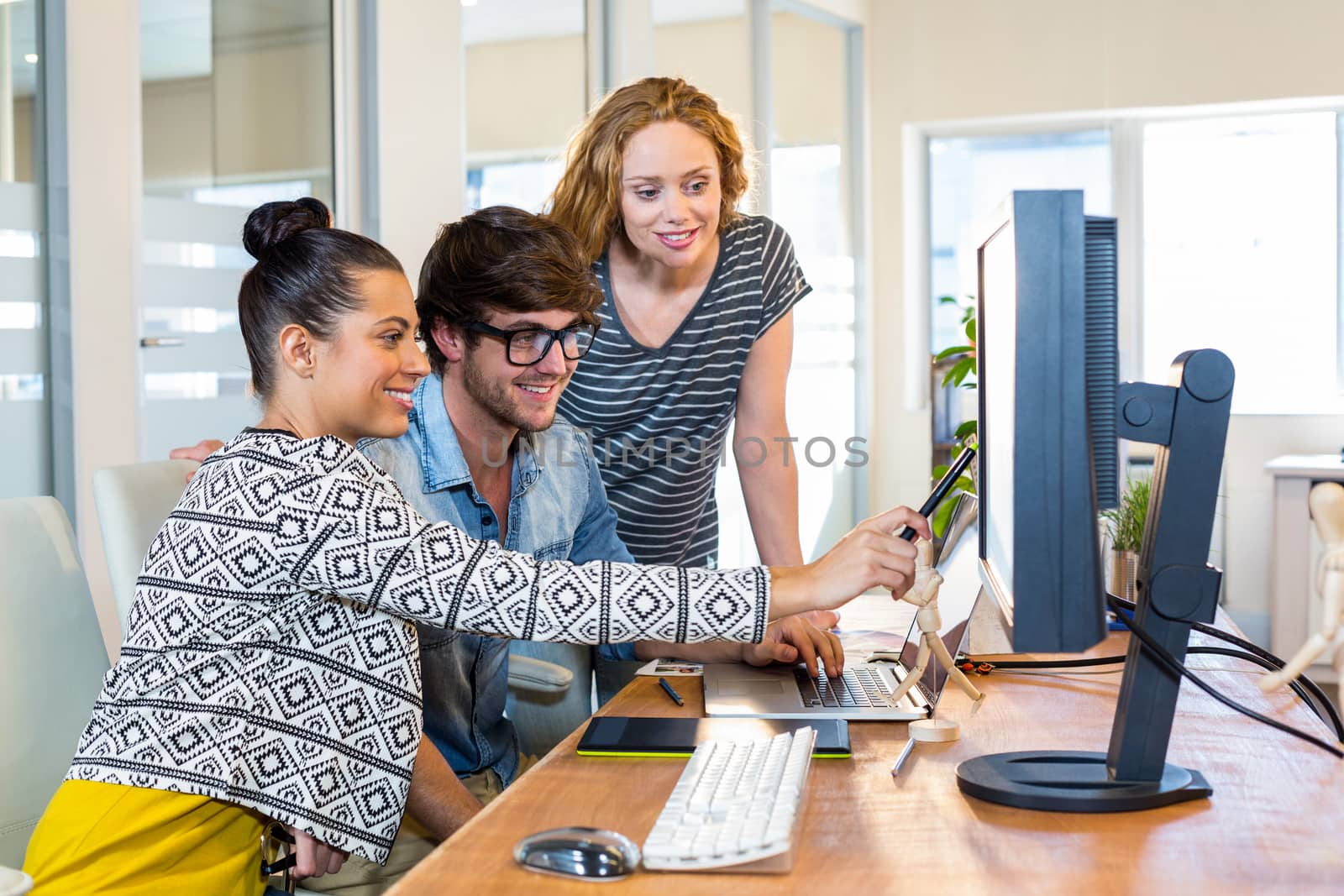 Professional designers working on computer by Wavebreakmedia