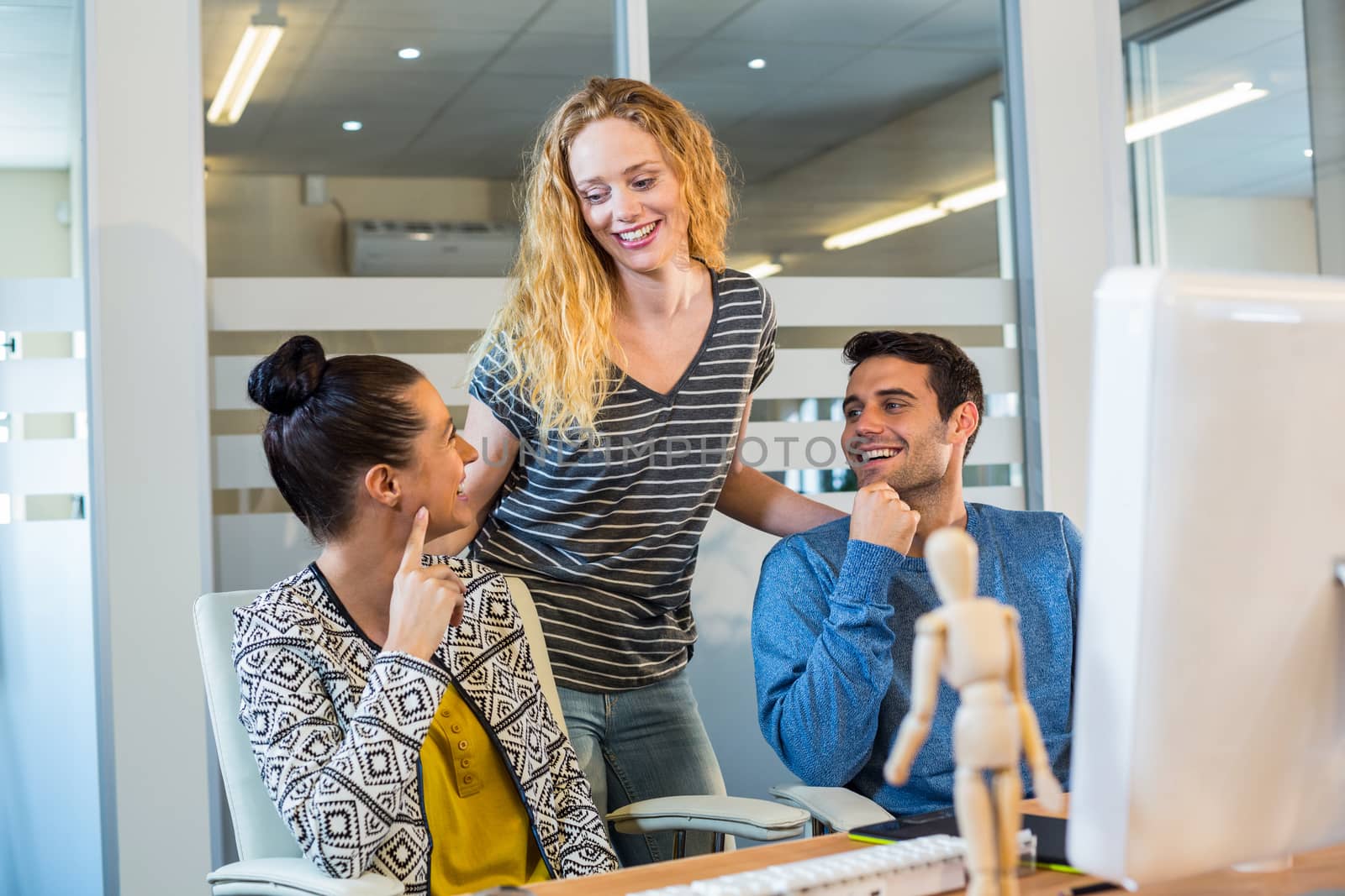 Smiling business laughing together in the office