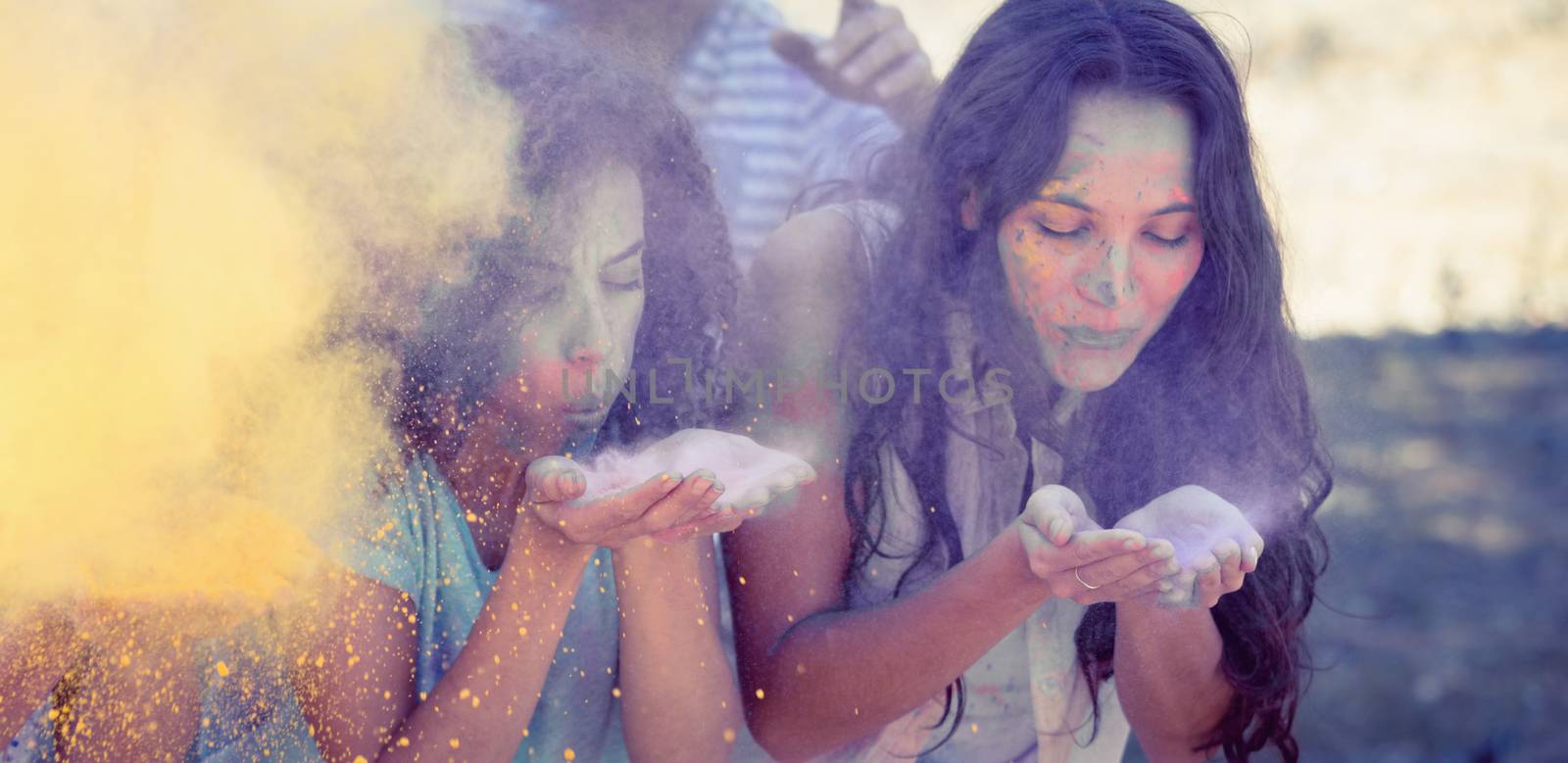 Young women having fun with powder paint by Wavebreakmedia