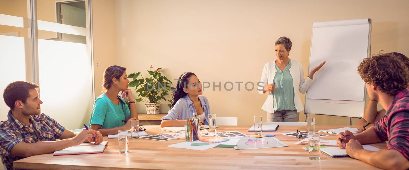 Casual businesswoman giving presentation to her colleagues by Wavebreakmedia