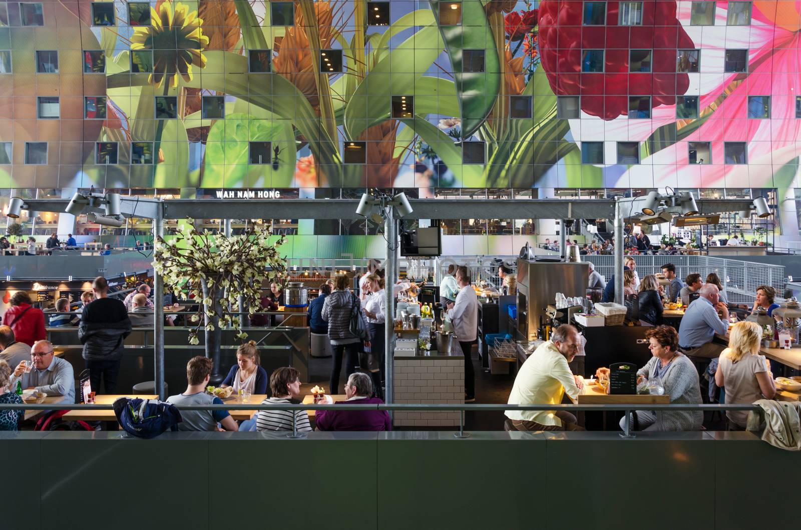 Rotterdam, Netherlands - May 9, 2015: People shopping at Markthal (Market hall) a new icon in Rotterdam. The covered food market and housing development shaped like a giant arch by Dutch architects MVRDV.