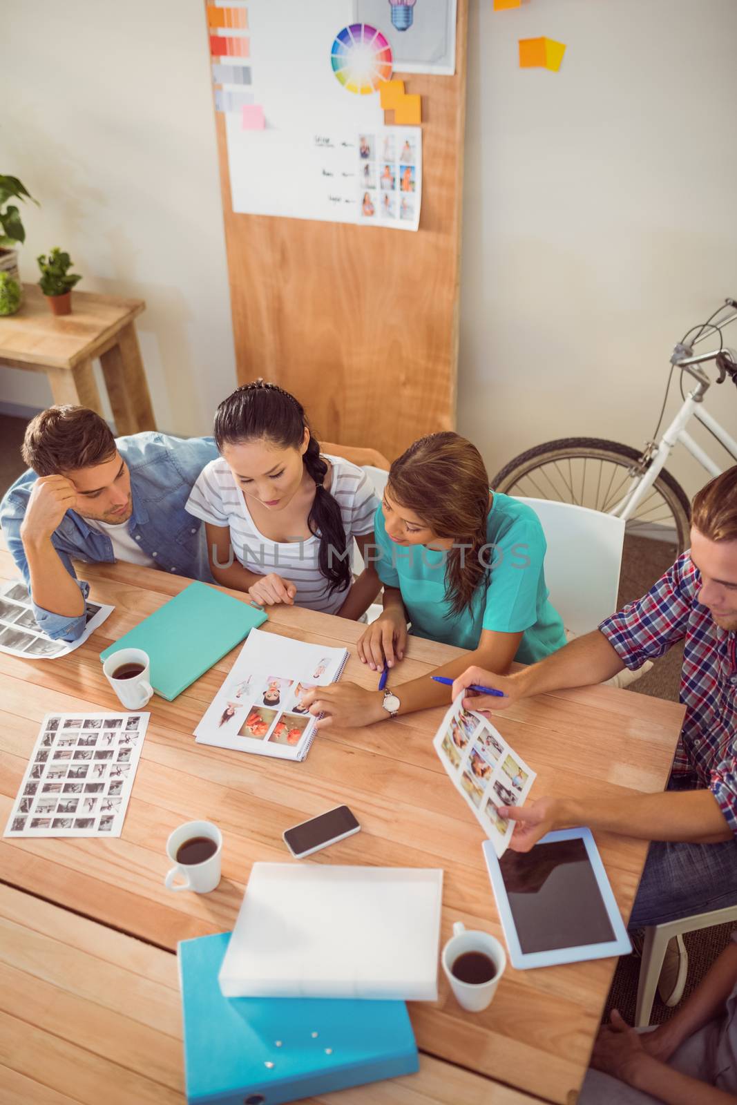 Seated creative business team working together by Wavebreakmedia