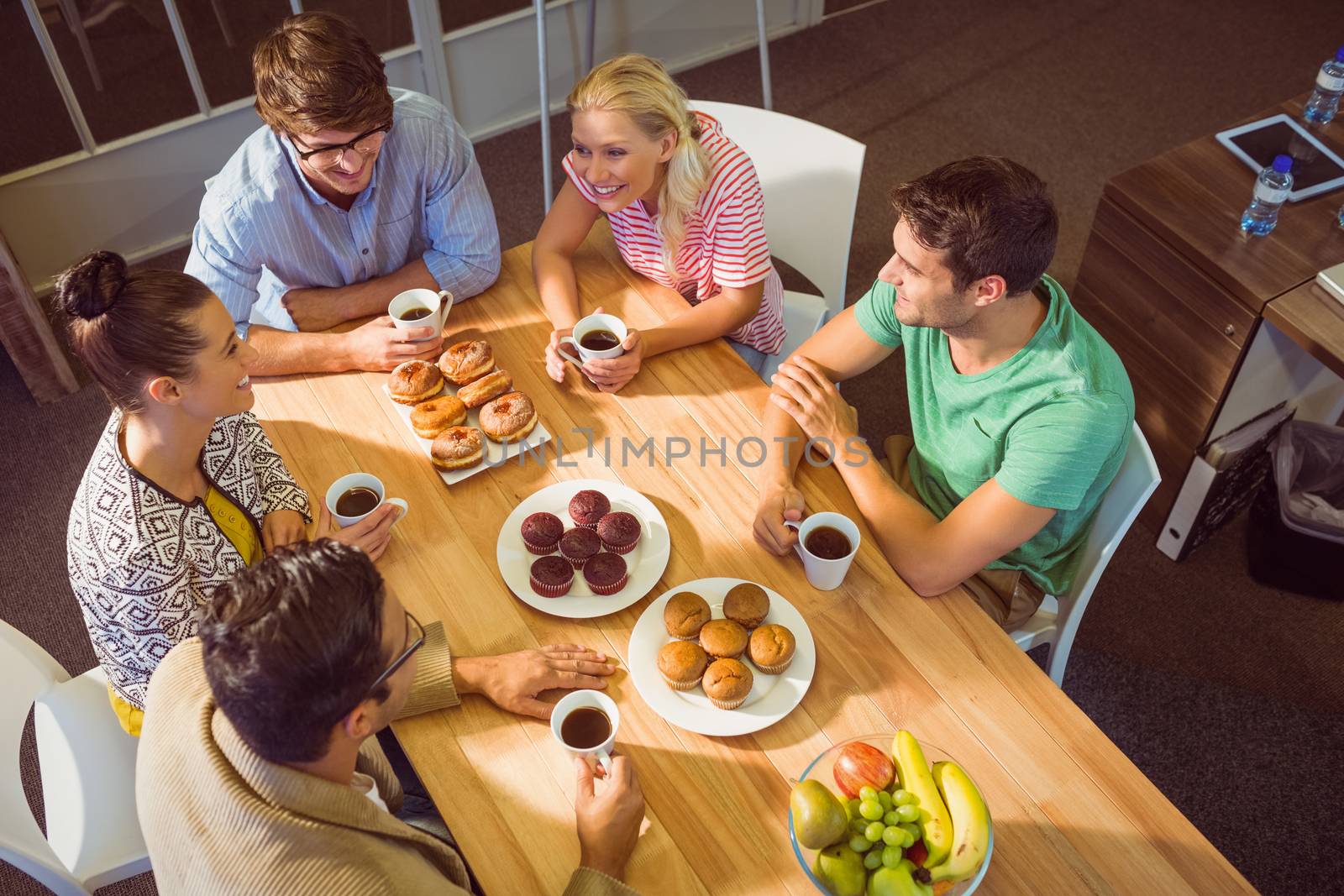 Young business people having dessert after lunch