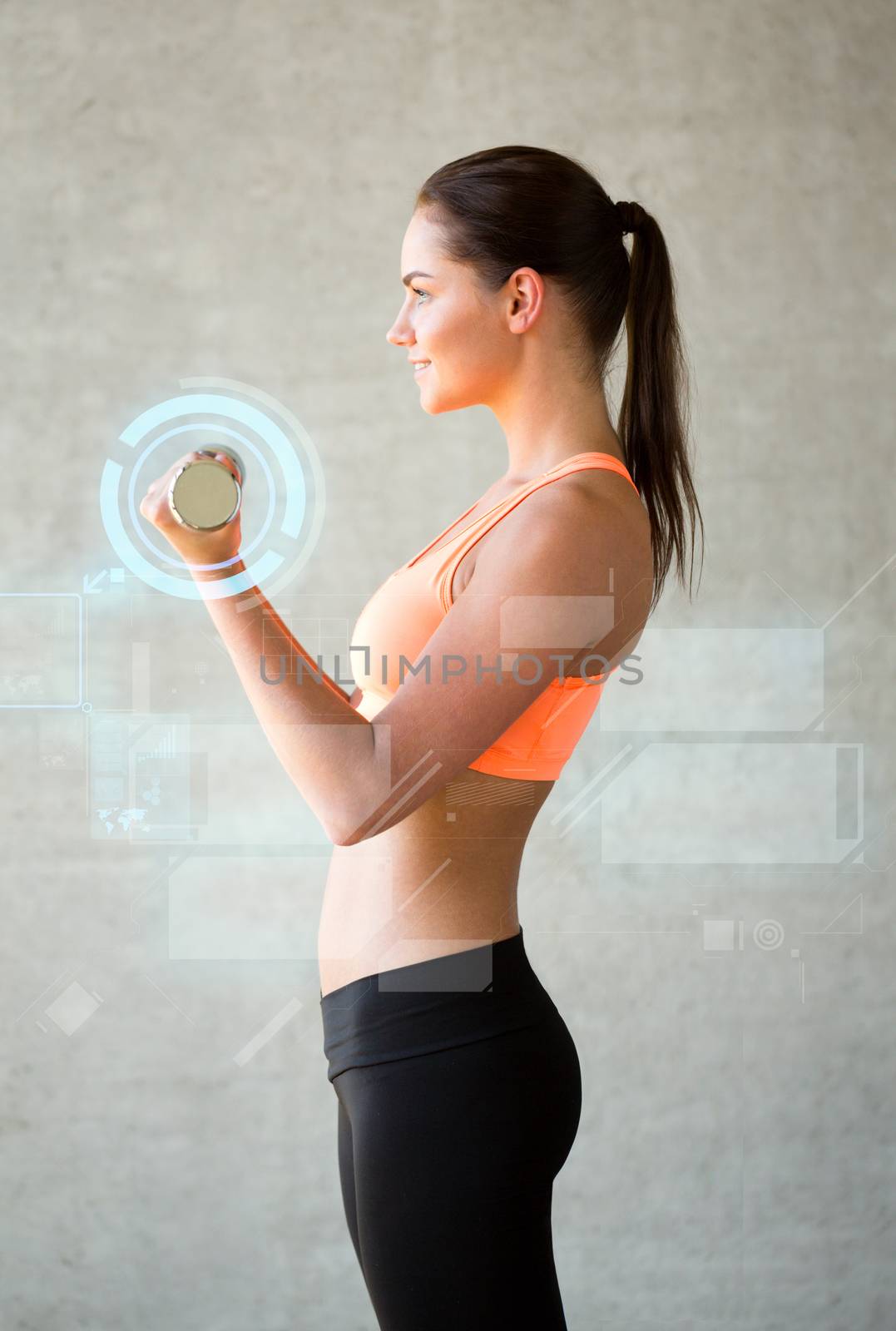 smiling woman with dumbbells in gym by dolgachov