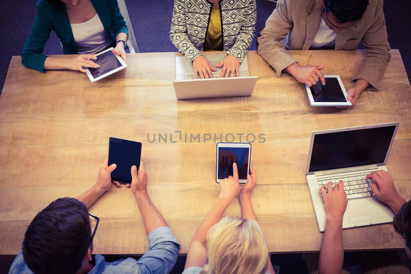 Young creative business people with laptop and digital tablet in the office