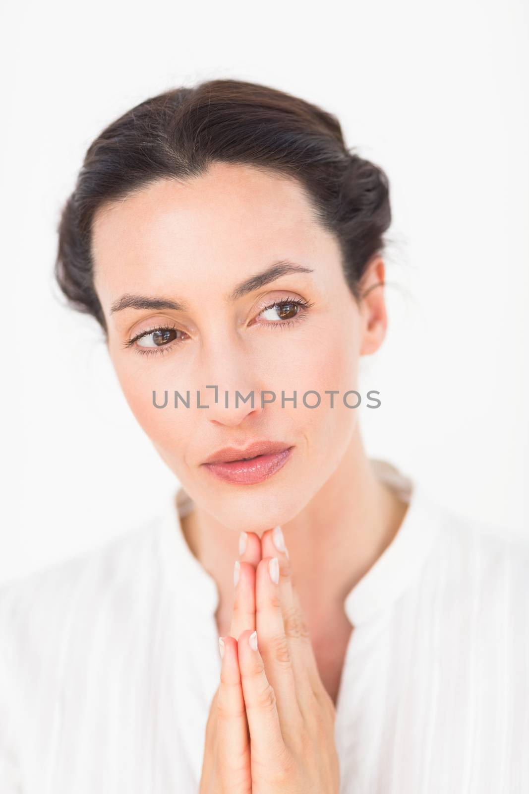 a woman in a meditation position against a white background