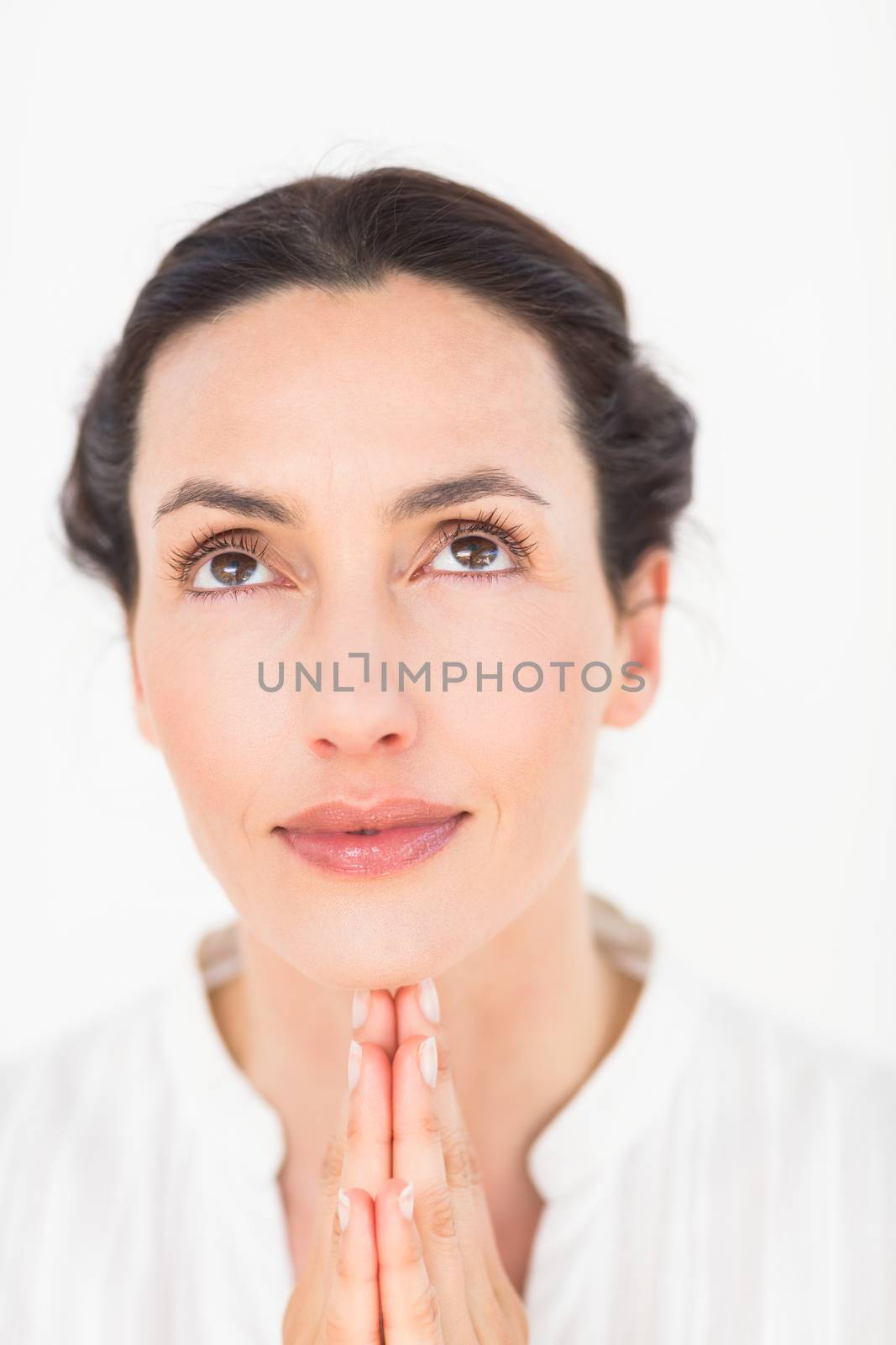 a woman in a meditation position against a white background