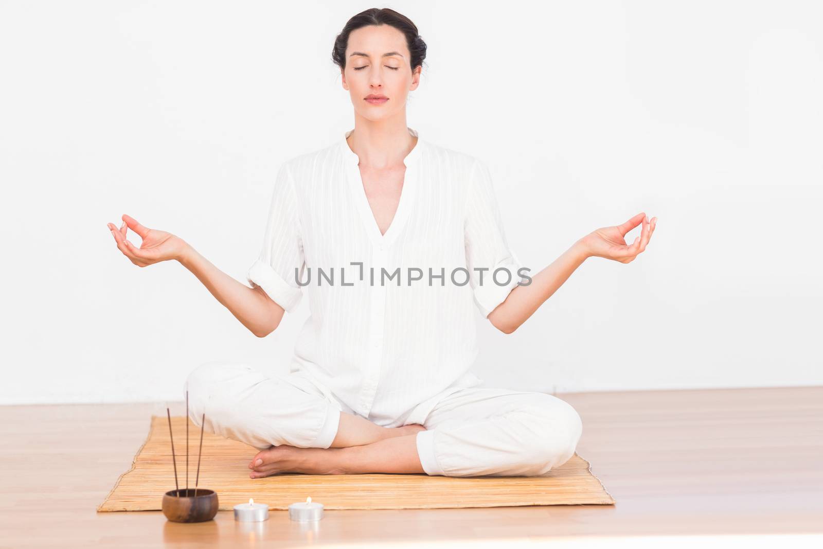 A woman in a meditation position by Wavebreakmedia