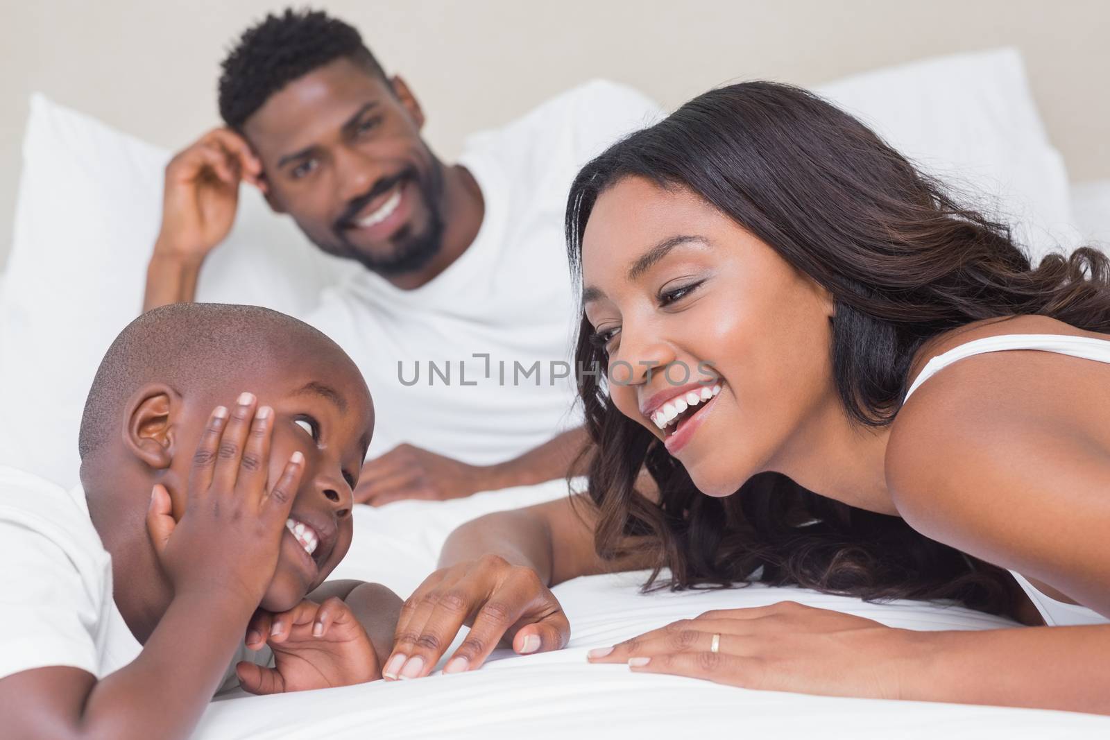 Happy family on the bed at home in bedroom