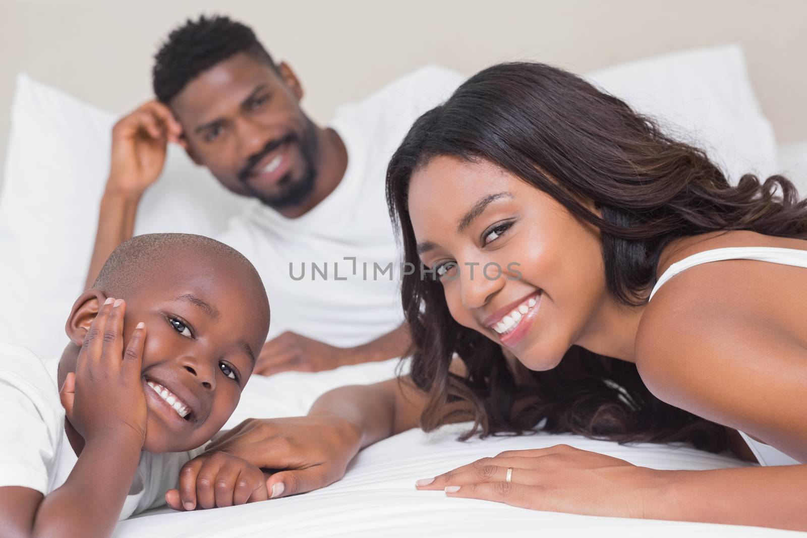 Happy family on the bed at home in bedroom