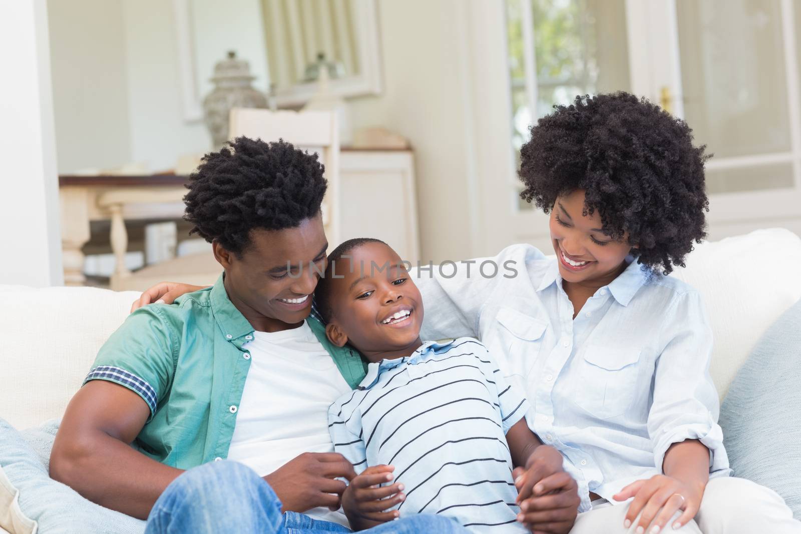 Happy family on the couch at home in the living room