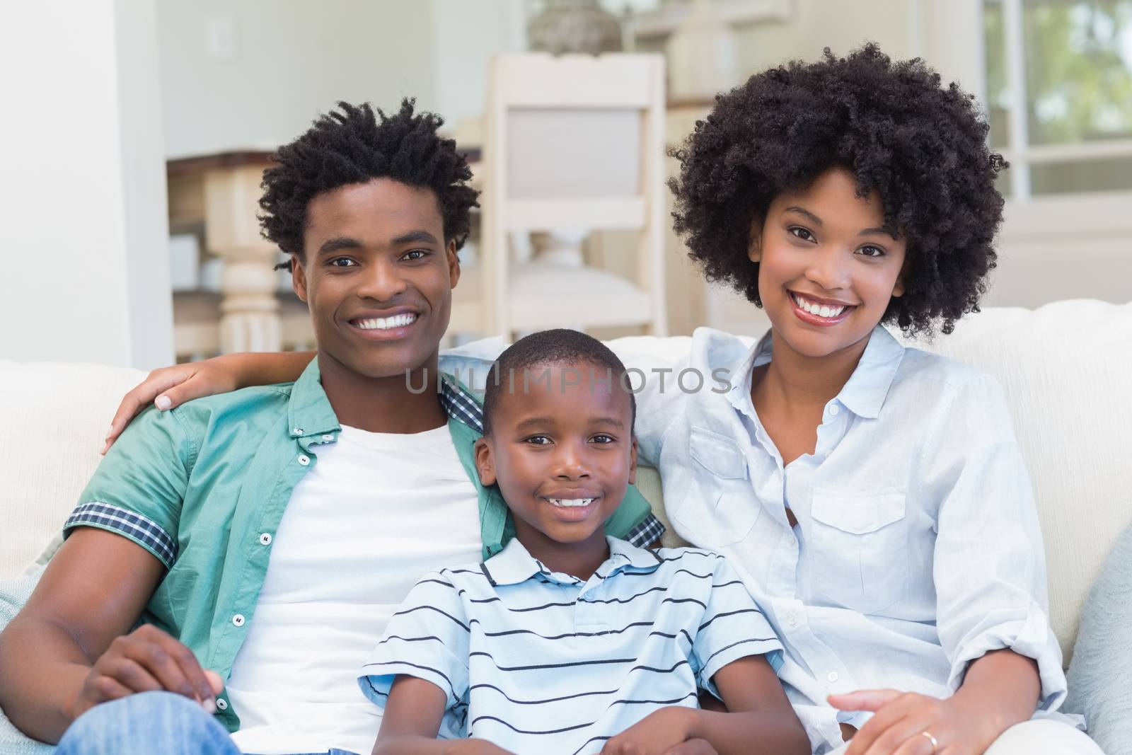 Happy family on the couch at home in the living room