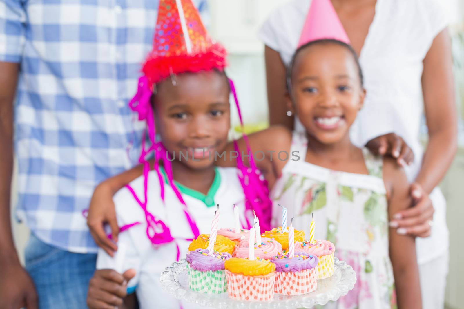 Happy family celebrating a birthday together at home in the kitchen