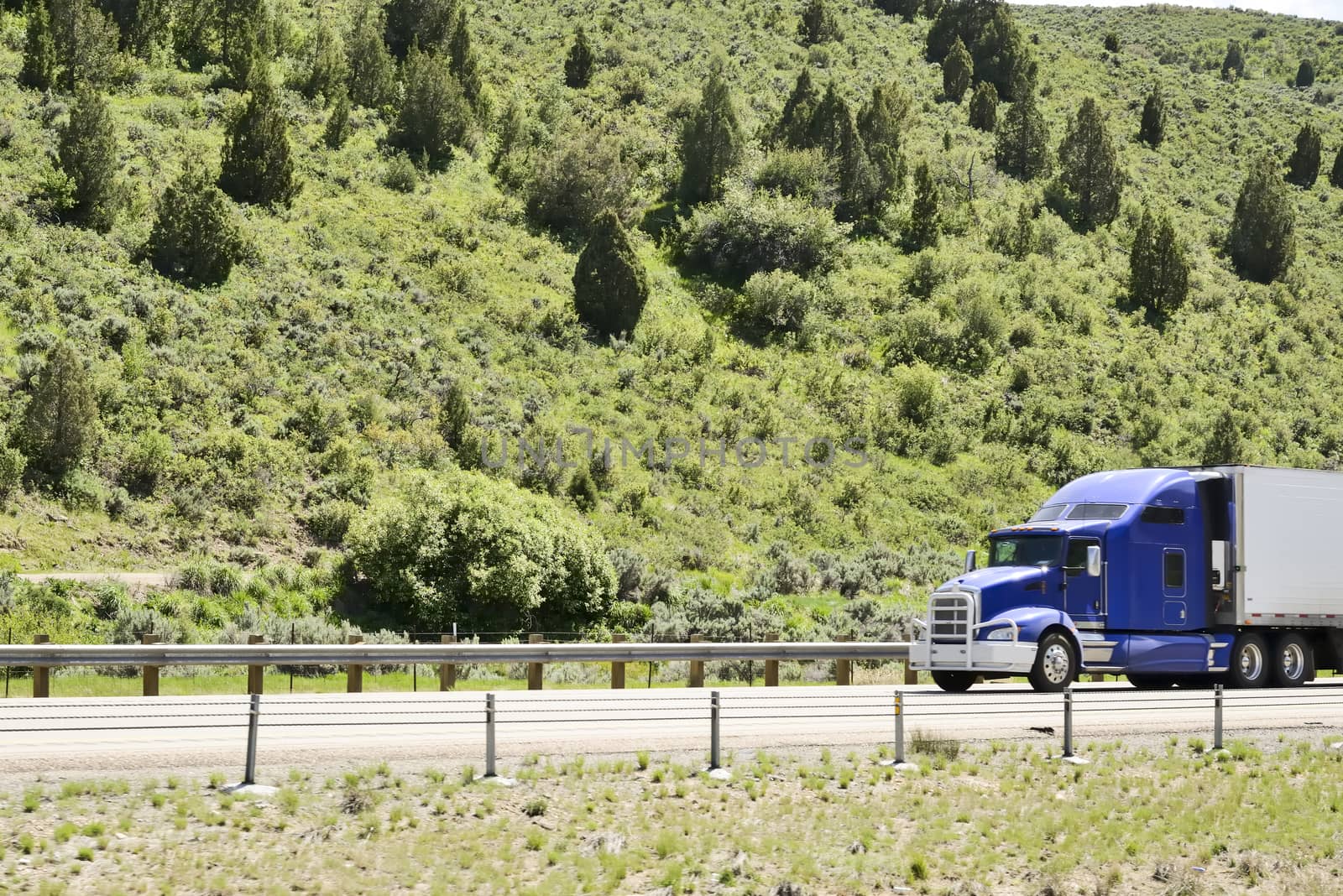 Shot of a big trucks traveling along the highway of the america.