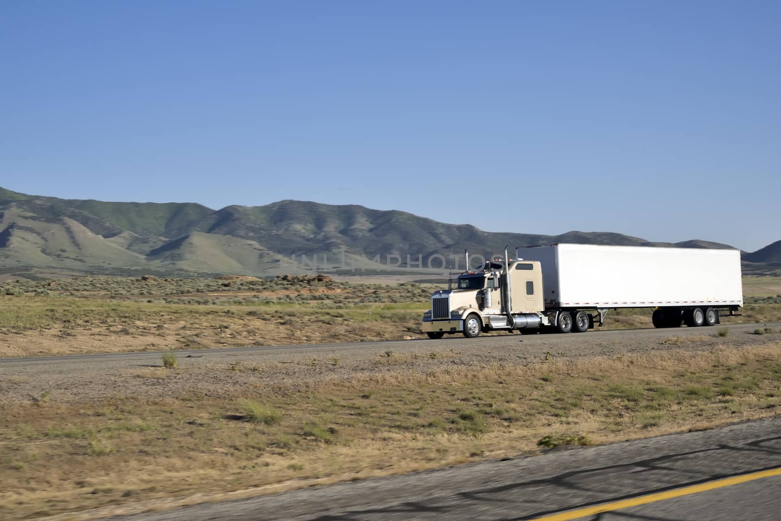 Shot of a big trucks traveling along the highway of the america.