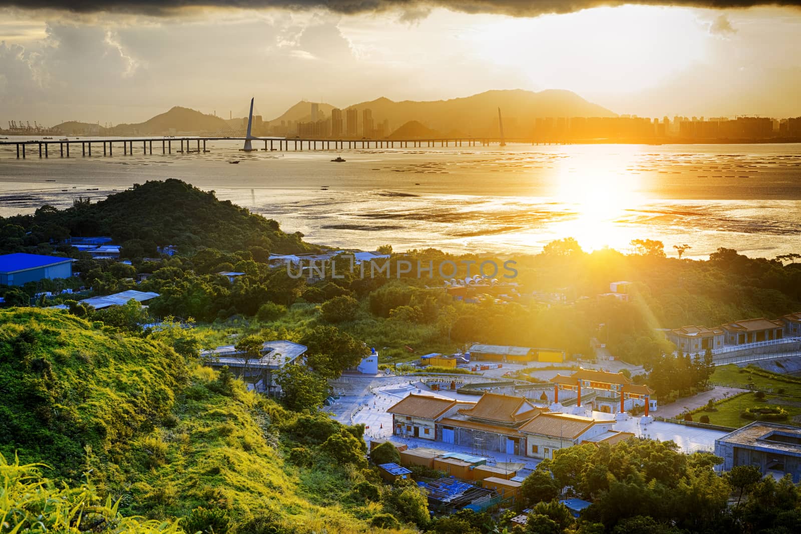 Village with beautiful sunset over hong kong  coastline. View from the top of mountain